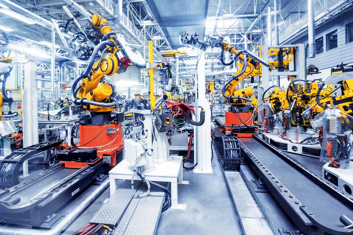 China product development with engineers reviewing prototypes in a manufacturing factory